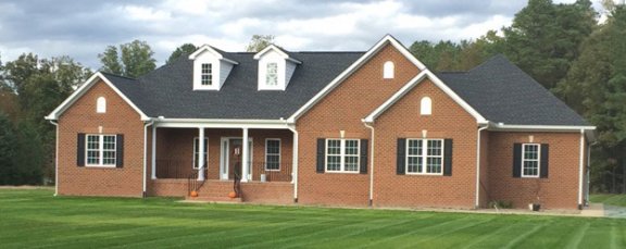 Finished custom house brick rancher elevation testimonial picture